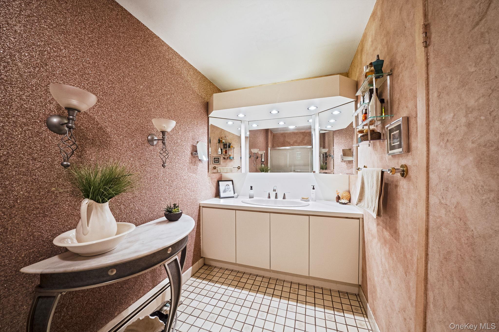 96 Fulton Boulevard Commack, NY 11725 - Photo 34 of 41 a bathroom with a sink a mirror and a toilet