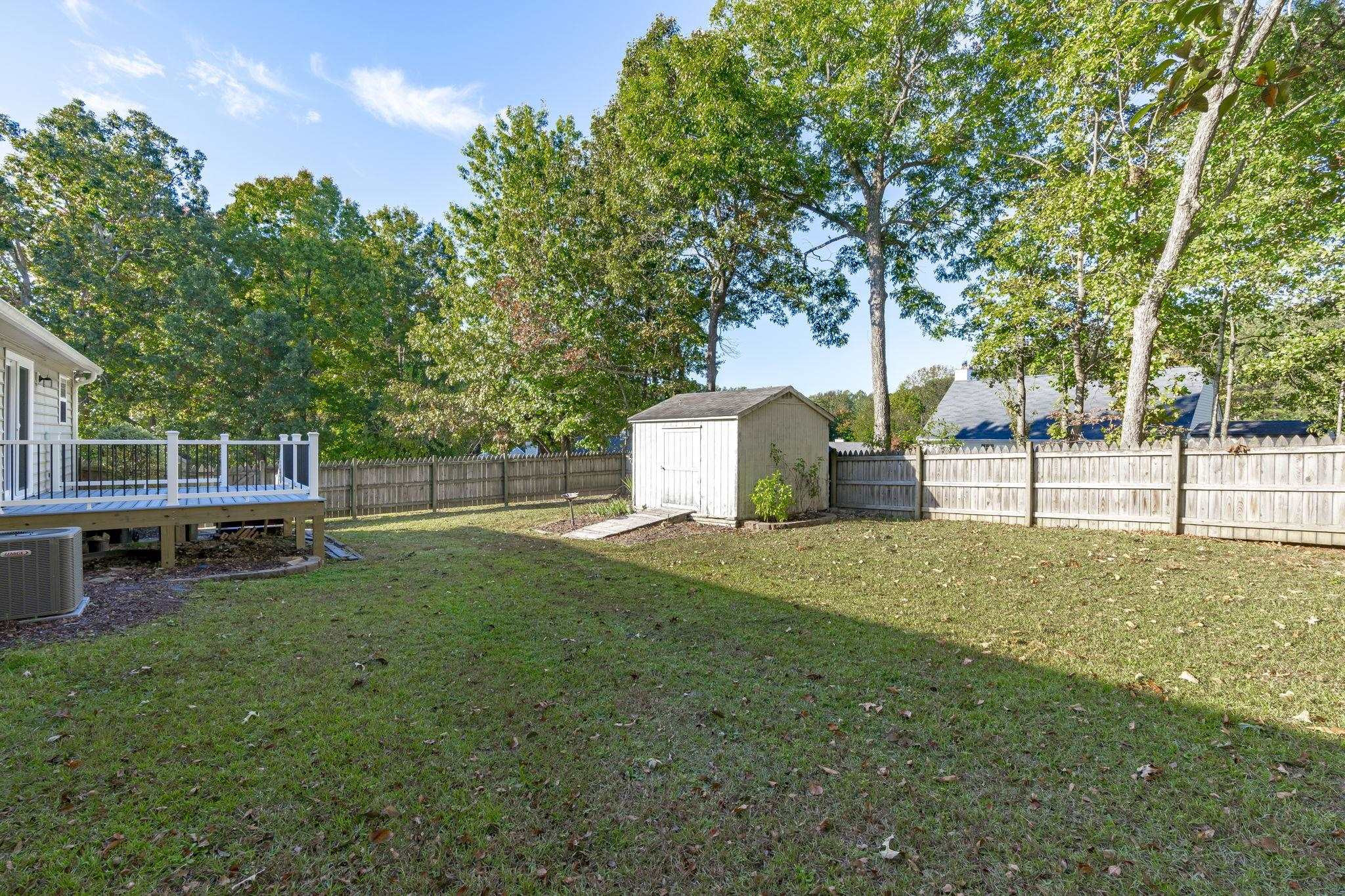 200 Peakhill Road Holly Springs, NC 27540 - Photo 15 of 18 a view of a backyard with a garden and trees