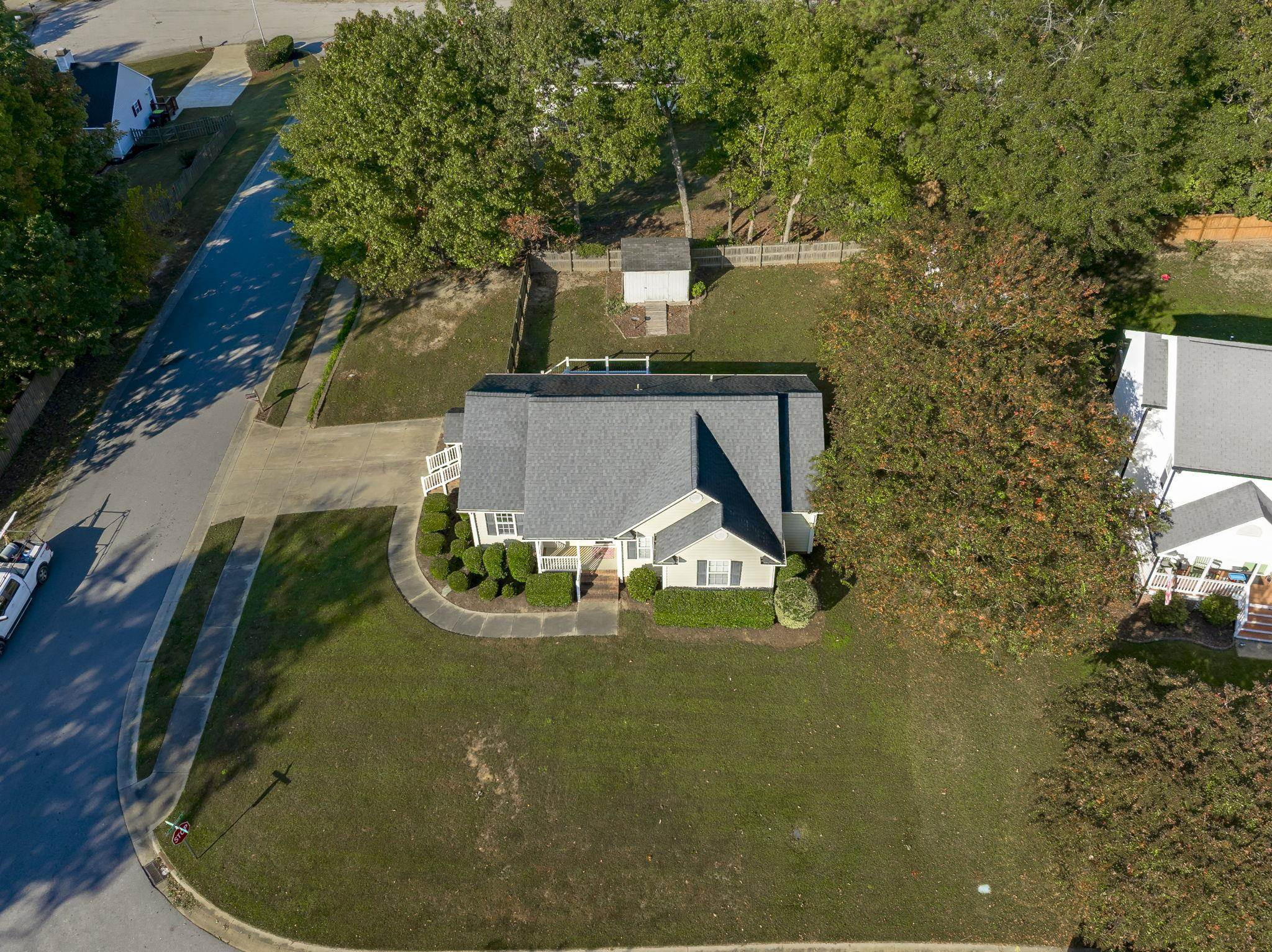 200 Peakhill Road Holly Springs, NC 27540 - Photo 17 of 18 an aerial view of a house with swimming pool and large trees
