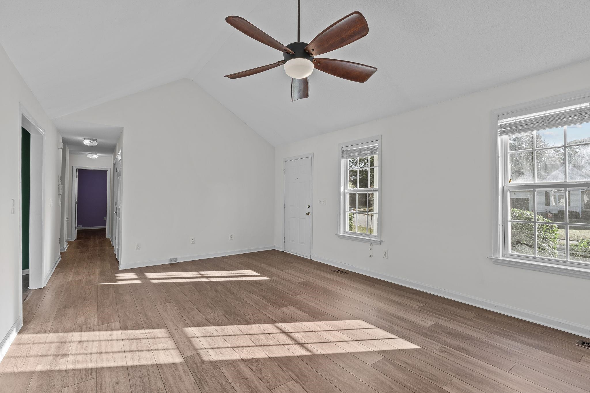 200 Peakhill Road Holly Springs, NC 27540 - Photo 4 of 18 a view of an empty room with window and wooden floor