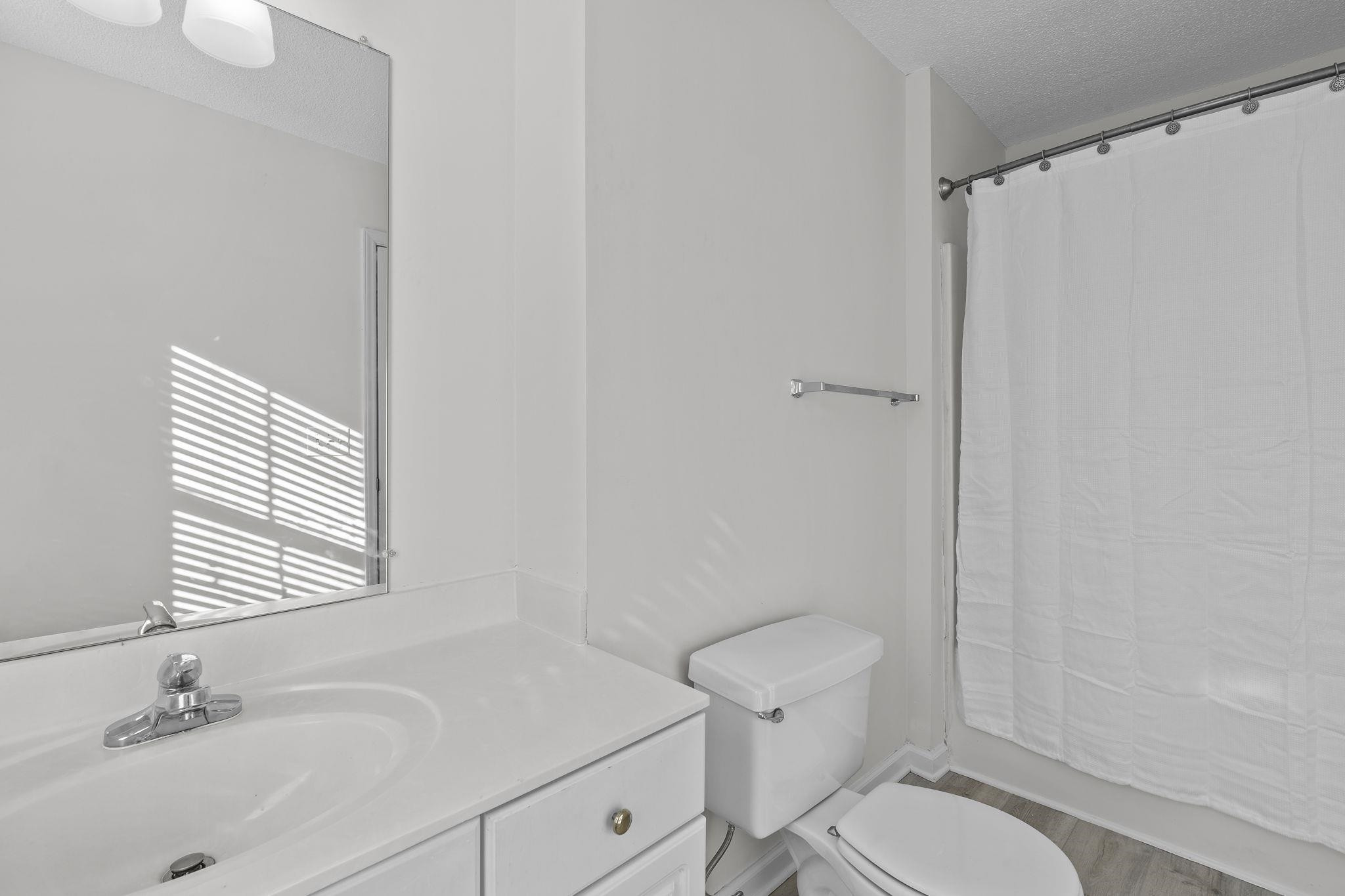 200 Peakhill Road Holly Springs, NC 27540 - Photo 8 of 18 a bathroom with a sink toilet and shower