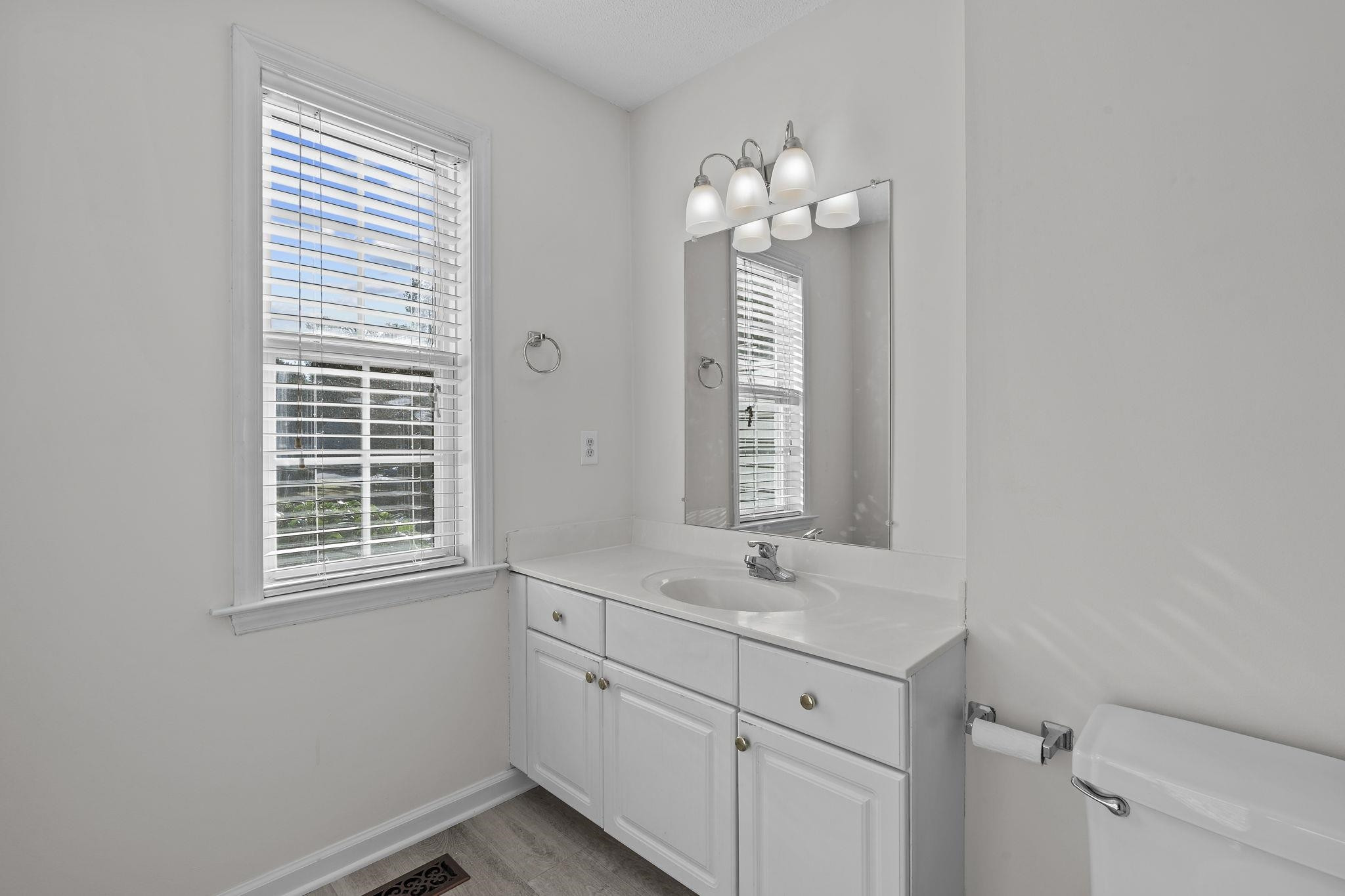 200 Peakhill Road Holly Springs, NC 27540 - Photo 9 of 18 a bathroom with a sink window and a mirror