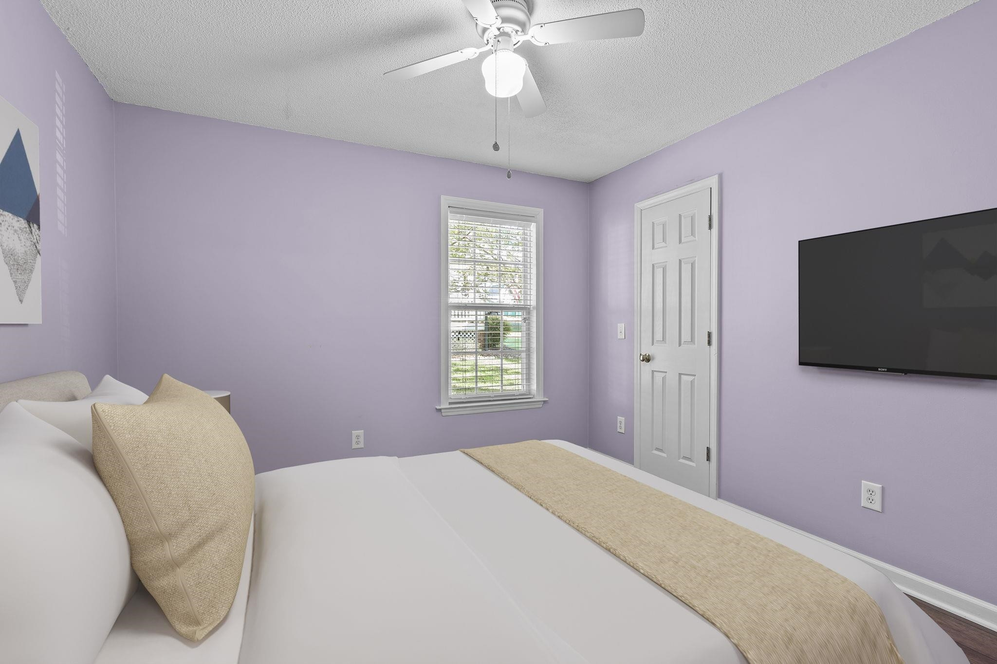 200 Peakhill Road Holly Springs, NC 27540 - Photo 10 of 18 a bedroom with a bed and a flat screen tv
