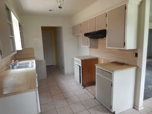 a kitchen with a stove and a refrigerator