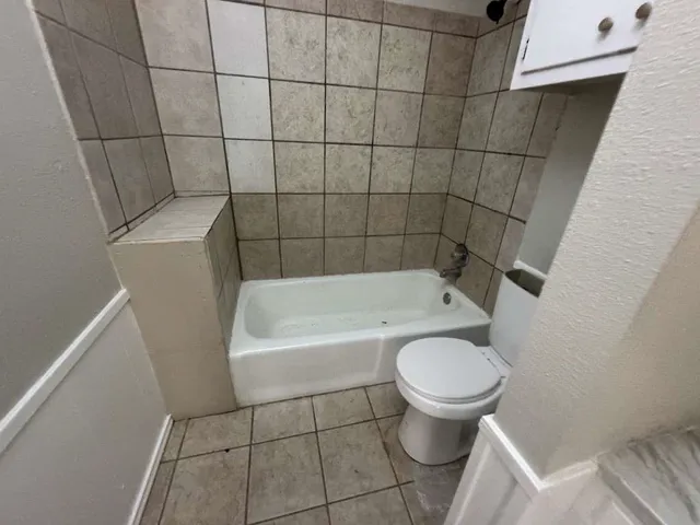 a bathroom with a toilet and a bathtub