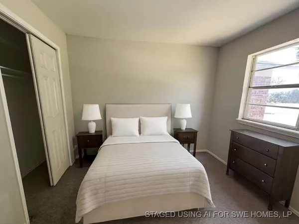 a bedroom with a bed and window