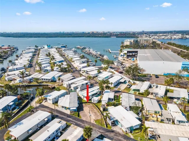 an aerial view of a city with lots of residential buildings and ocean view