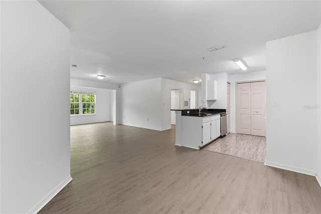 a view of kitchen with sink and wooden floor