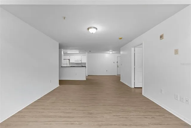 a view of a kitchen with a sink and refrigerator
