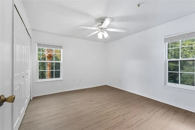 wooden floor in an empty room with a window