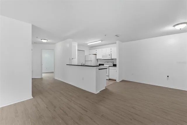 a view of kitchen with wooden floor