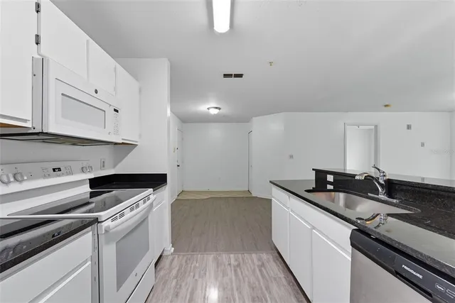 a kitchen that has a sink and a stove