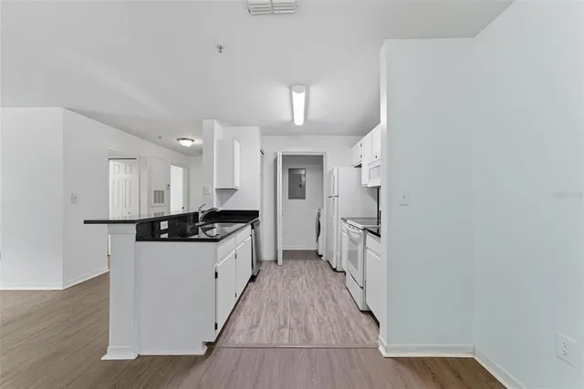 a kitchen with granite countertop a sink and a stove top oven