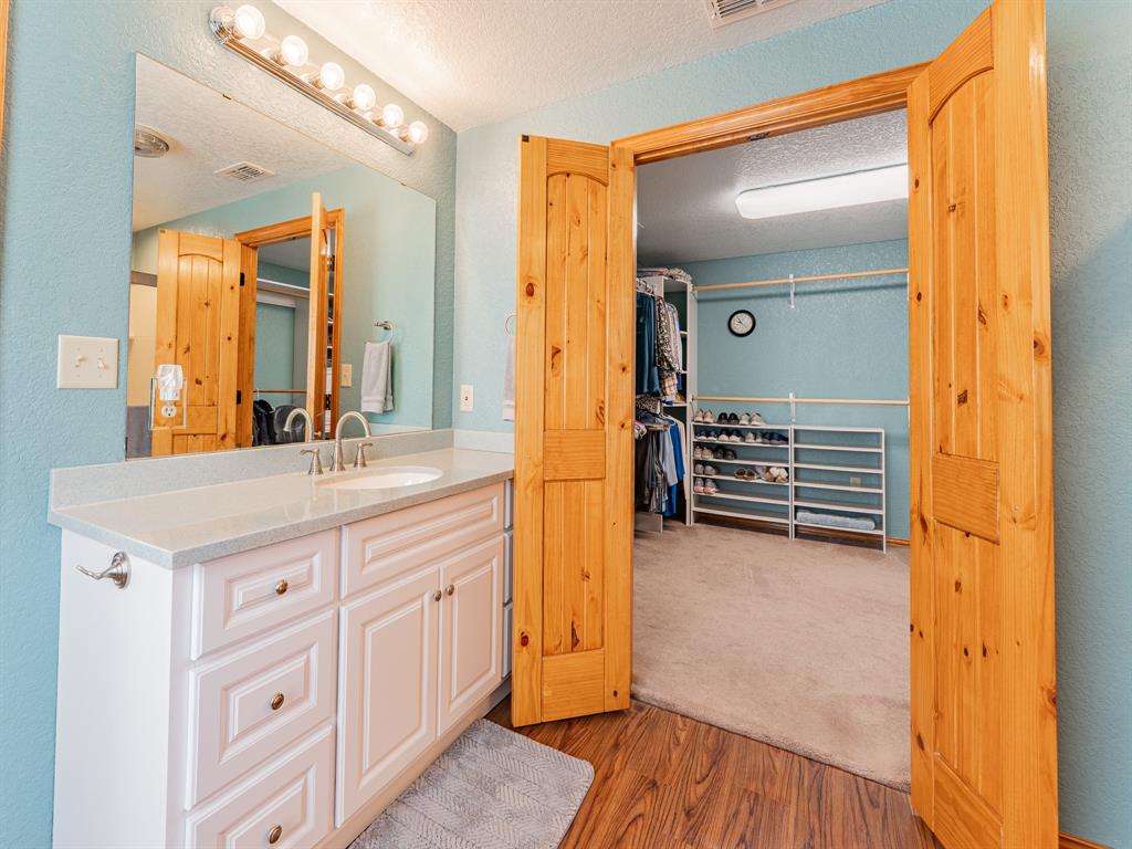 1857 Old Bonita Road Nocona, TX 76255 - Photo 11 of 39 a bathroom with a granite countertop sink and a mirror