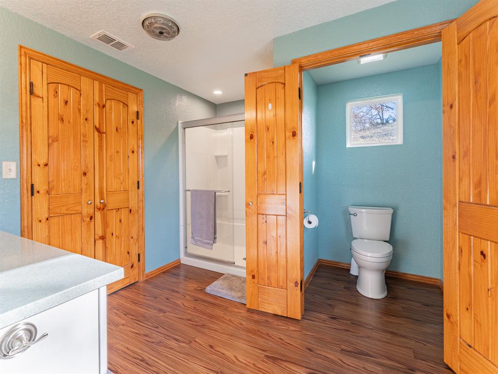 1857 Old Bonita Road Nocona, TX 76255 - Photo 12 of 39 a bathroom with a sink a toilet and shower