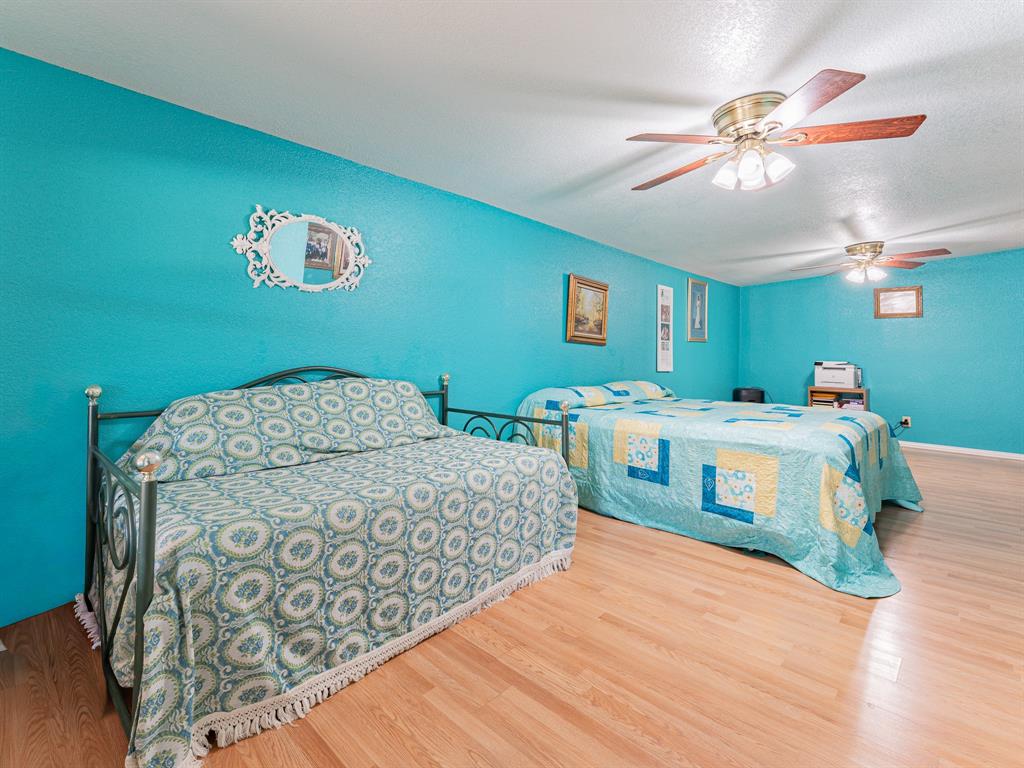 1857 Old Bonita Road Nocona, TX 76255 - Photo 13 of 39 a bedroom with a bed and a chandelier