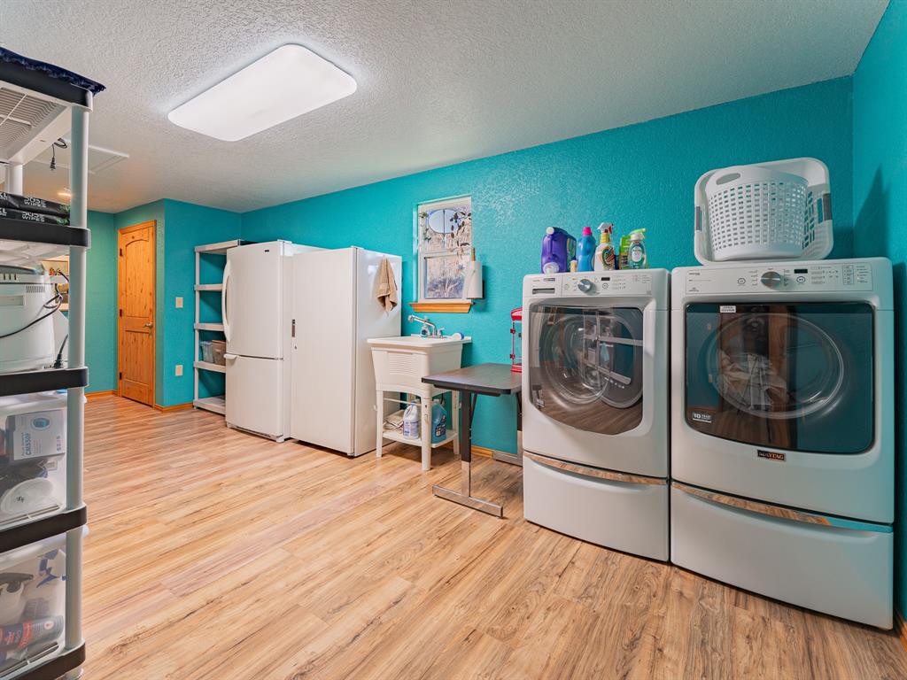 1857 Old Bonita Road Nocona, TX 76255 - Photo 17 of 39 a utility room with wooden floor washer and dryer