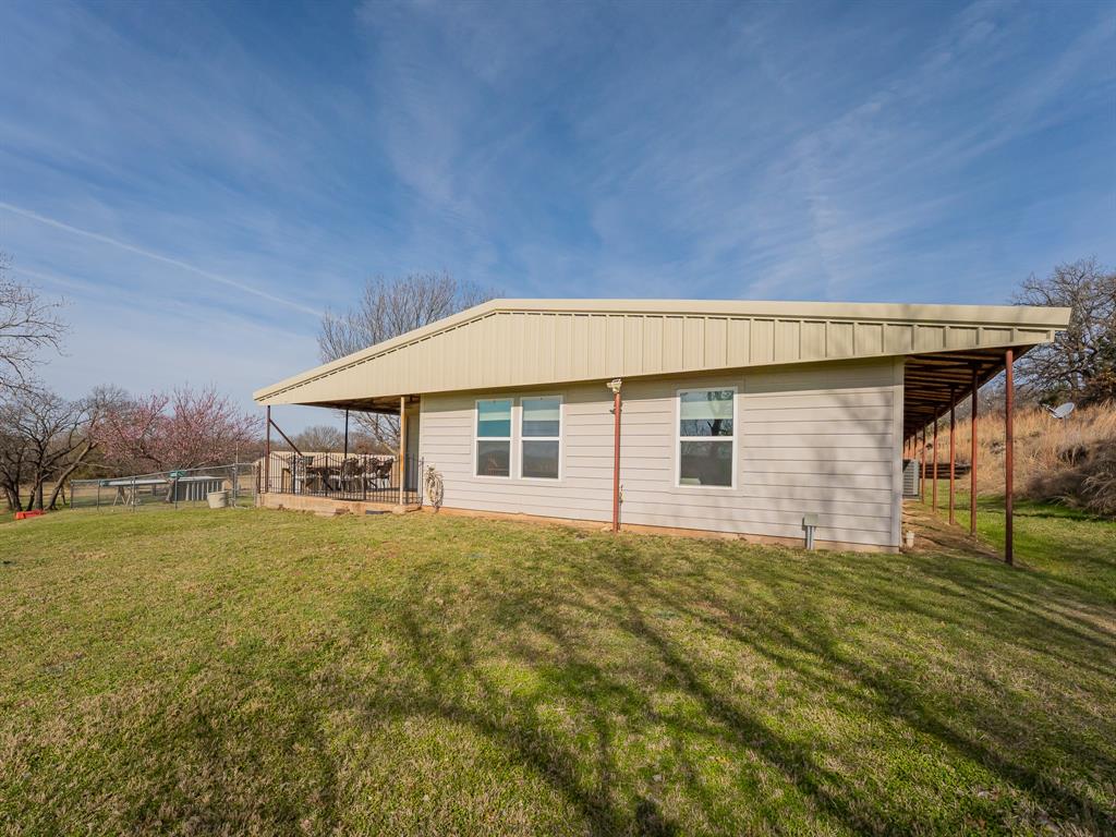 1857 Old Bonita Road Nocona, TX 76255 - Photo 22 of 39 a view of a house with backyard and trees