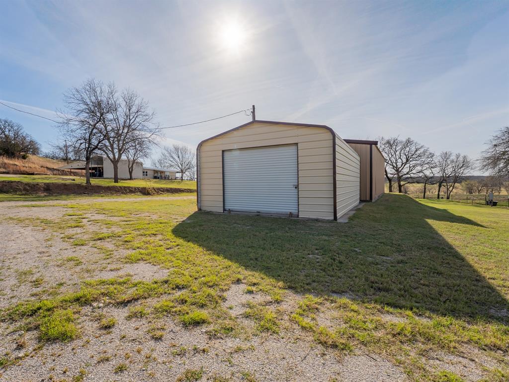 1857 Old Bonita Road Nocona, TX 76255 - Photo 26 of 39 a front view of a house with garden