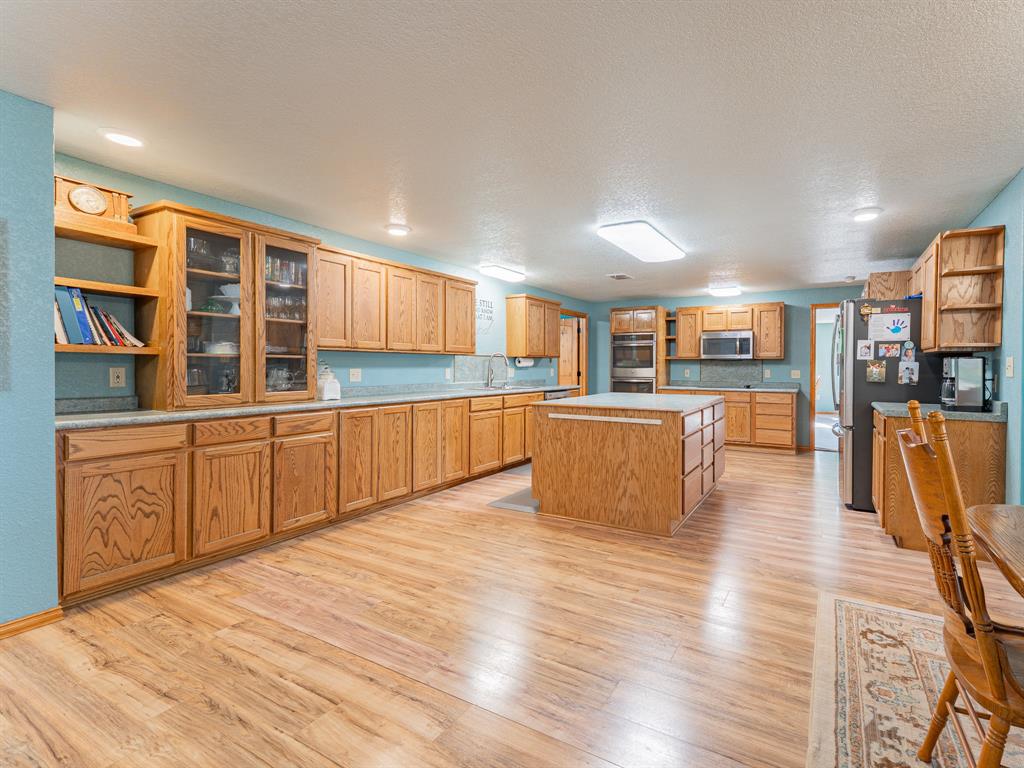 1857 Old Bonita Road Nocona, TX 76255 - Photo 7 of 39 a large kitchen with stainless steel appliances granite countertop a large center island and a sink