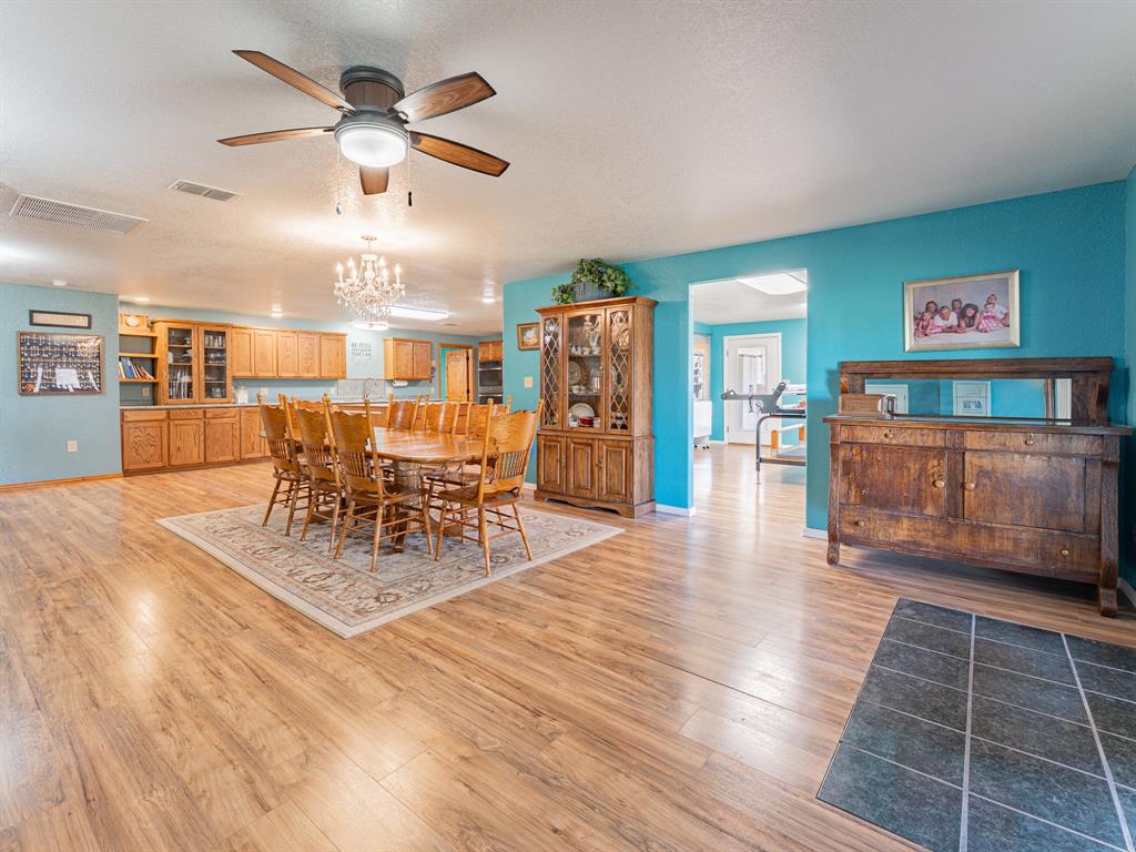 1857 Old Bonita Road Nocona, TX 76255 - Photo 8 of 39 a view of a dining room with furniture and wooden floor