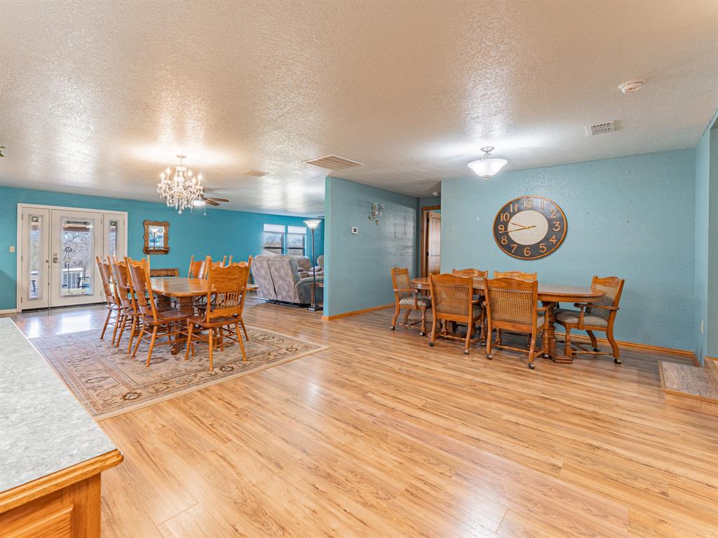 1857 Old Bonita Road Nocona, TX 76255 - Photo 9 of 39 a dining room with furniture a rug and wooden floor