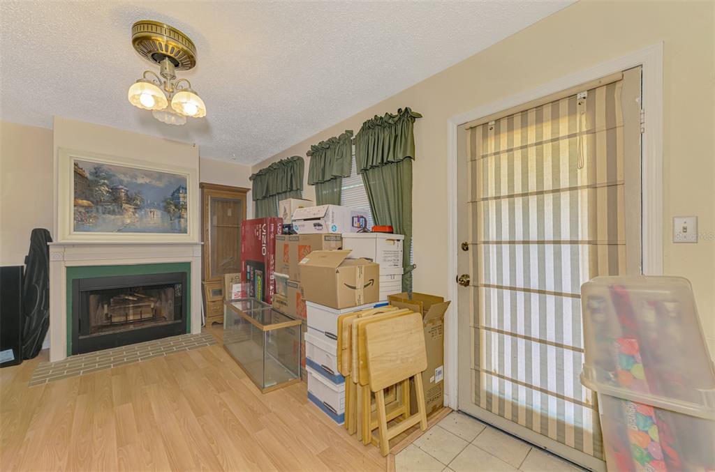 1137 Ponderosa Road Venice, FL 34293 - Photo 34 of 48 a living room with furniture and a fireplace