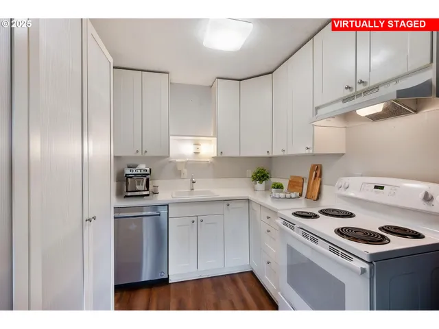 a kitchen with a sink a stove and cabinets