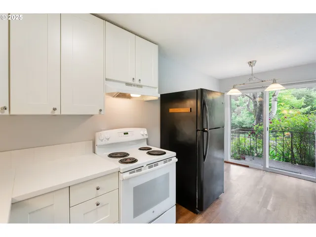 a open area with window and wooden floor