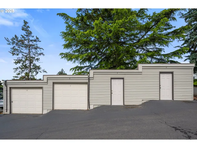 a view of a house with a big yard and potted plants