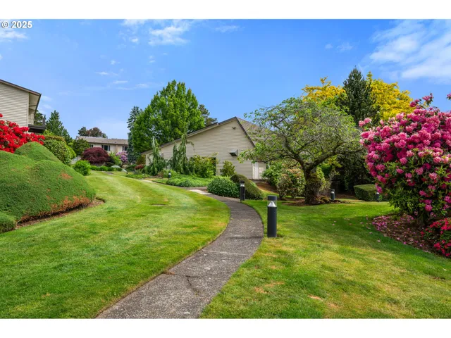 a view of a garden with a building in the background