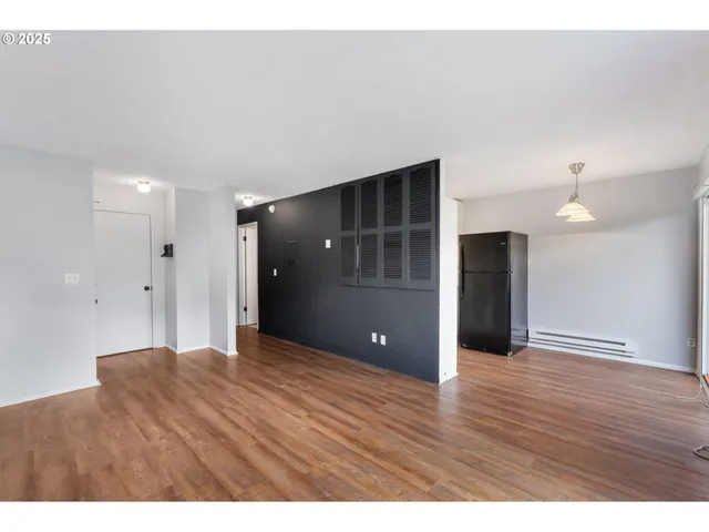 a view of an empty room and wooden floor
