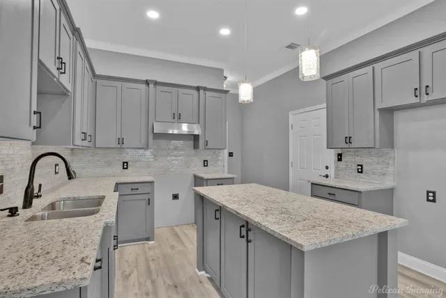 a kitchen with white cabinets appliances and sink