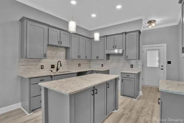 a kitchen with a sink stove and cabinets
