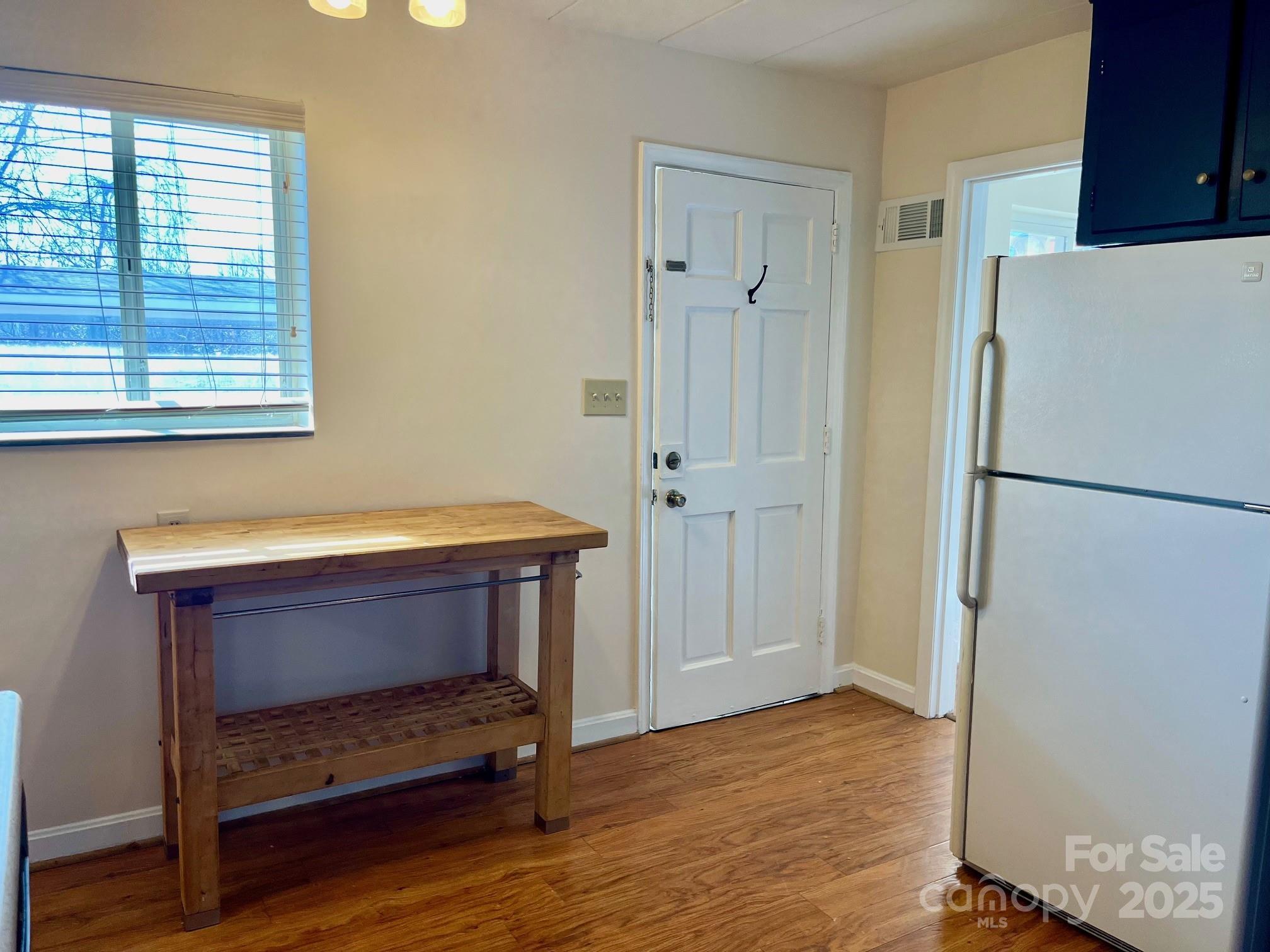 3010 Crosby Road, Unit 122 Charlotte, NC 28211 - Photo 12 of 38 a room with a table and a refrigerator