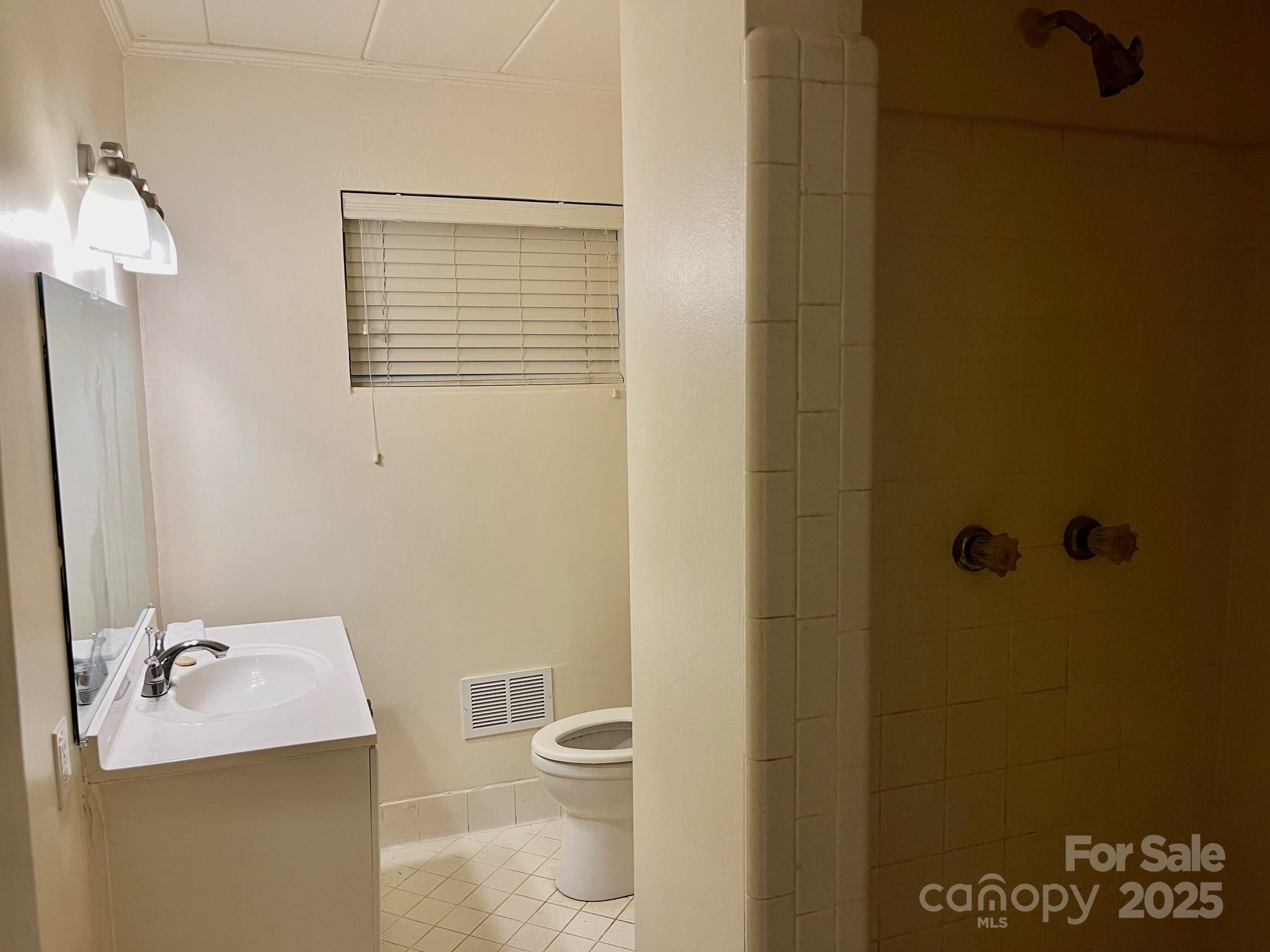 3010 Crosby Road, Unit 122 Charlotte, NC 28211 - Photo 24 of 38 a bathroom with a sink and mirror with toilet