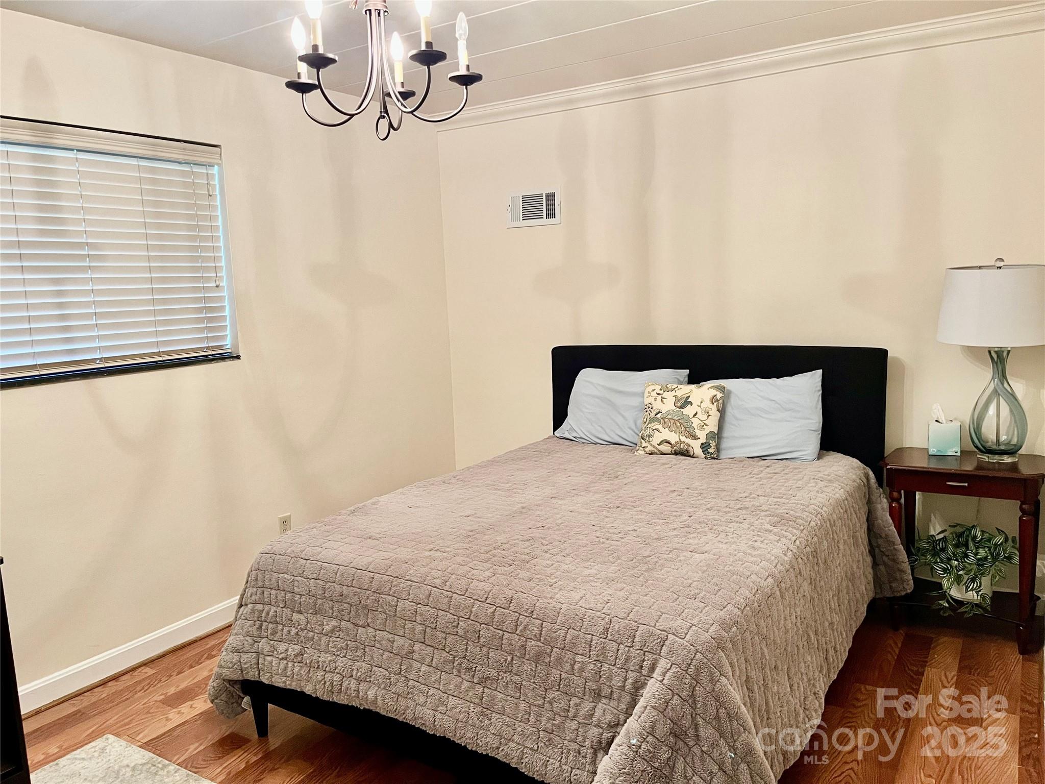 3010 Crosby Road, Unit 122 Charlotte, NC 28211 - Photo 26 of 38 a bedroom with a bed and wooden floor
