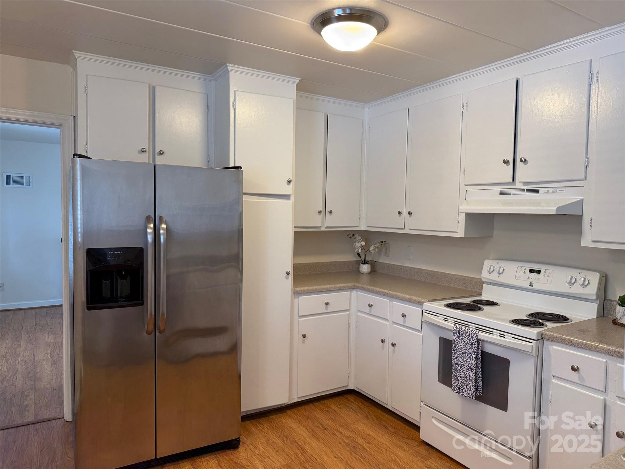 3010 Crosby Road, Unit 122 Charlotte, NC 28211 - Photo 10 of 38 a kitchen with a refrigerator sink and cabinets