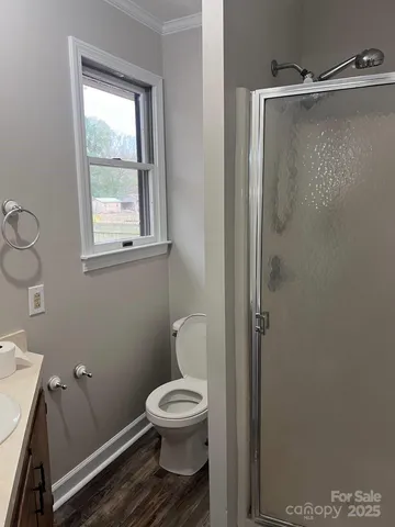 a white toilet sitting next to a bathroom sink