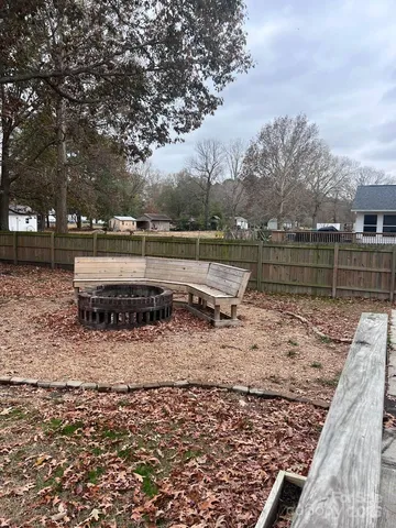 a view of a yard with wooden fence
