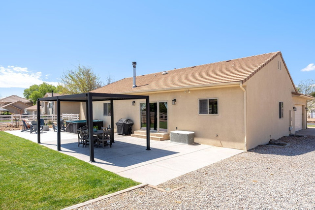 7776 Wagon Road East St. George, UT 84770 - Photo 49 of 76 Rear view of house featuring a patio, stucco siding, a lawn, and a tile roof