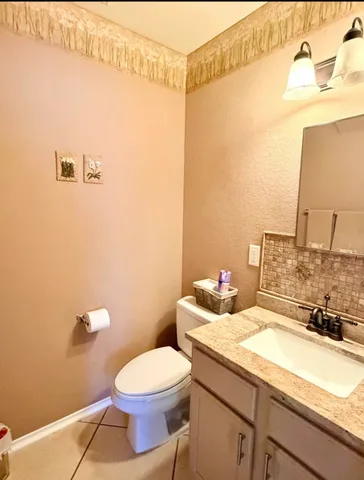 a living room with furniture and a dining table with kitchen view