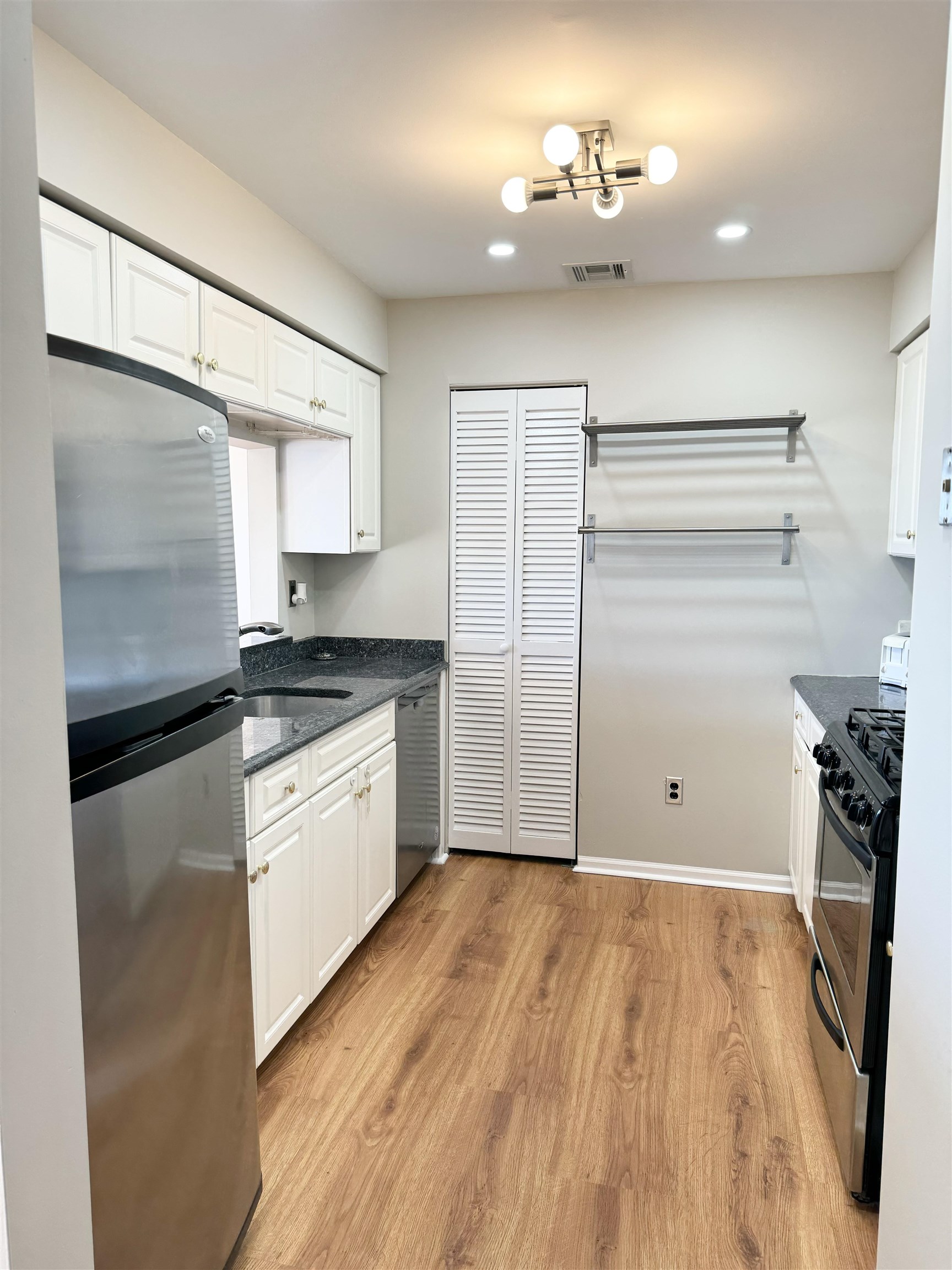 22 Bergen Ridge Road, Unit 2 North Bergen, NJ 07047 - Photo 4 of 15 a kitchen with a refrigerator and white cabinets