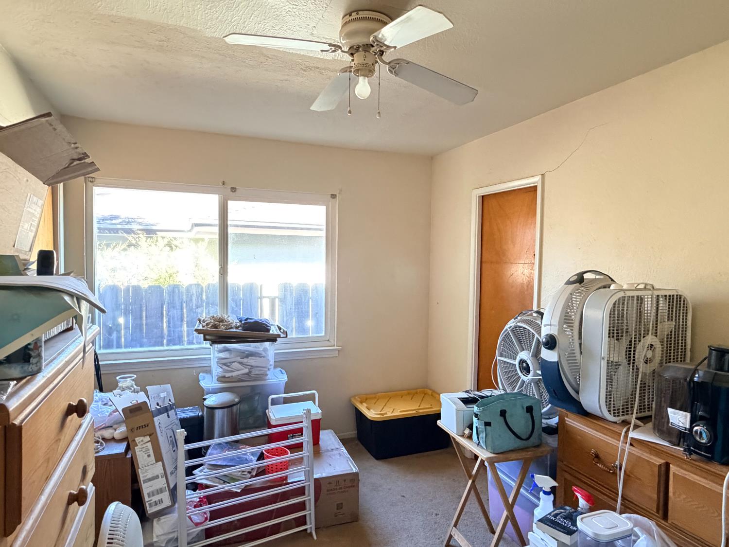 15445 West E Street Kerman, CA 93630 - Photo 9 of 12 a room with furniture and a window