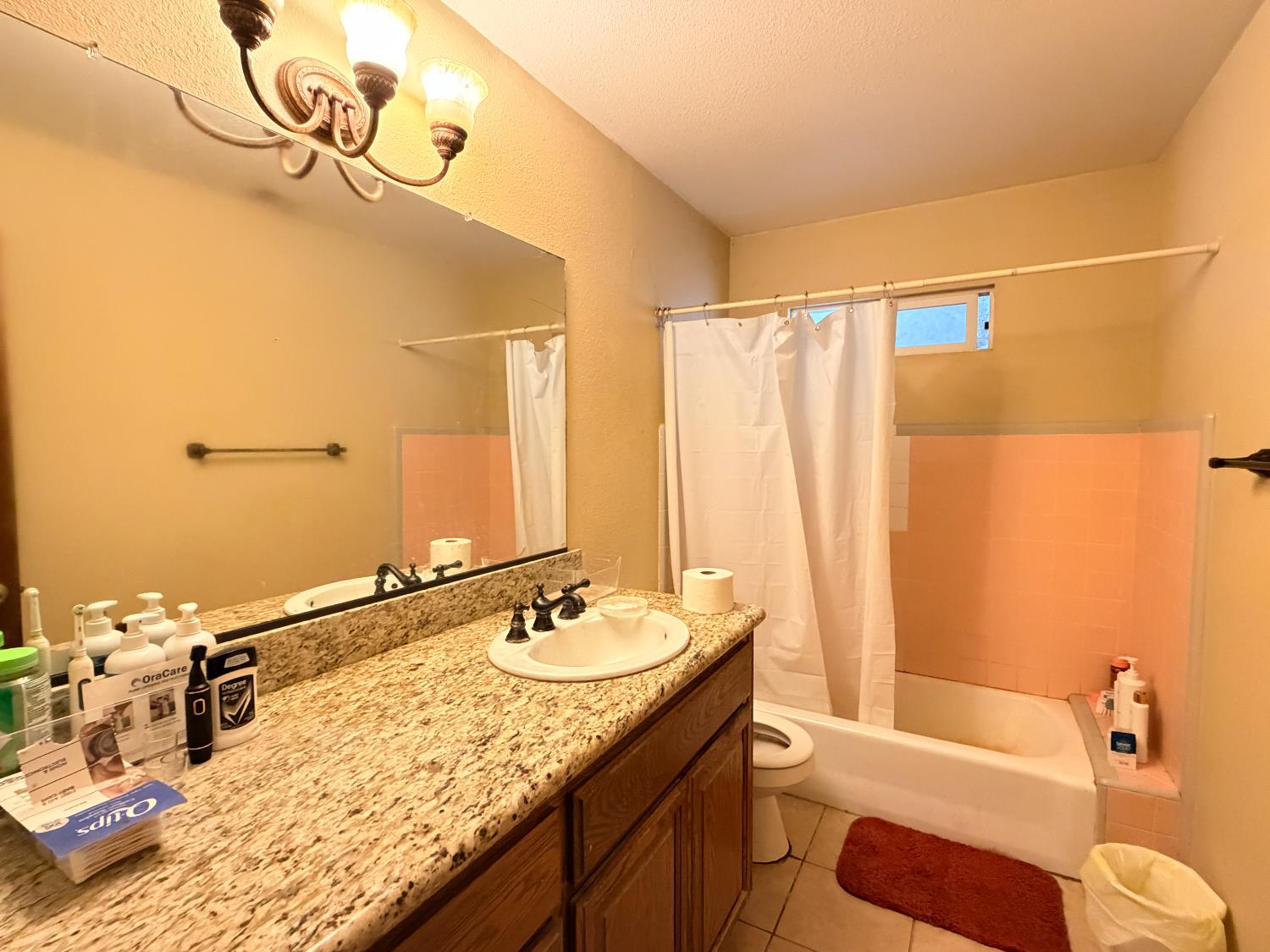 15445 West E Street Kerman, CA 93630 - Photo 10 of 12 a bathroom with a granite countertop sink and a mirror
