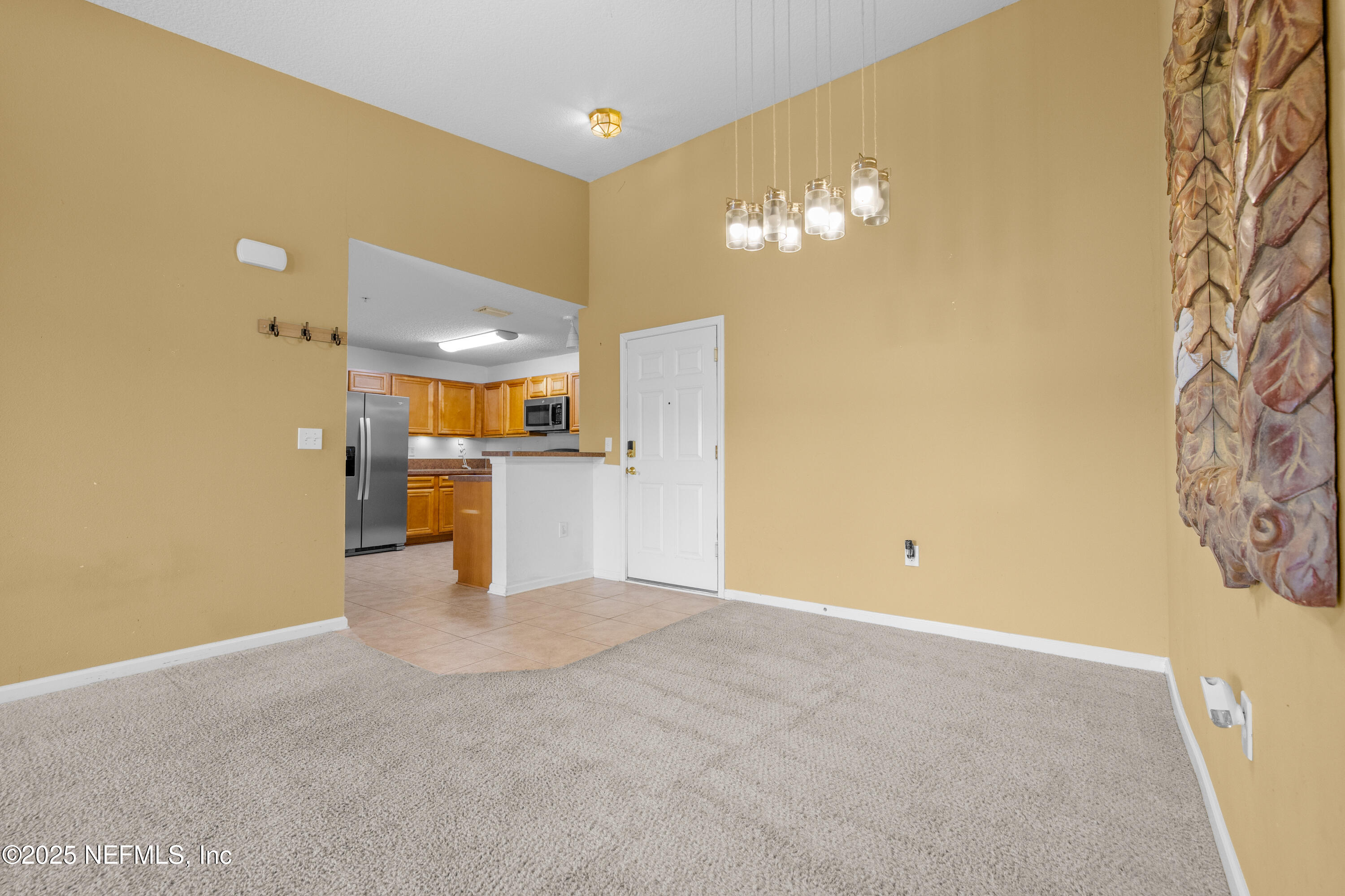 2784 Golden Lake Loop St. Augustine, FL 32084 - Photo 21 of 32 a view of a kitchen with a fridge and wooden floor