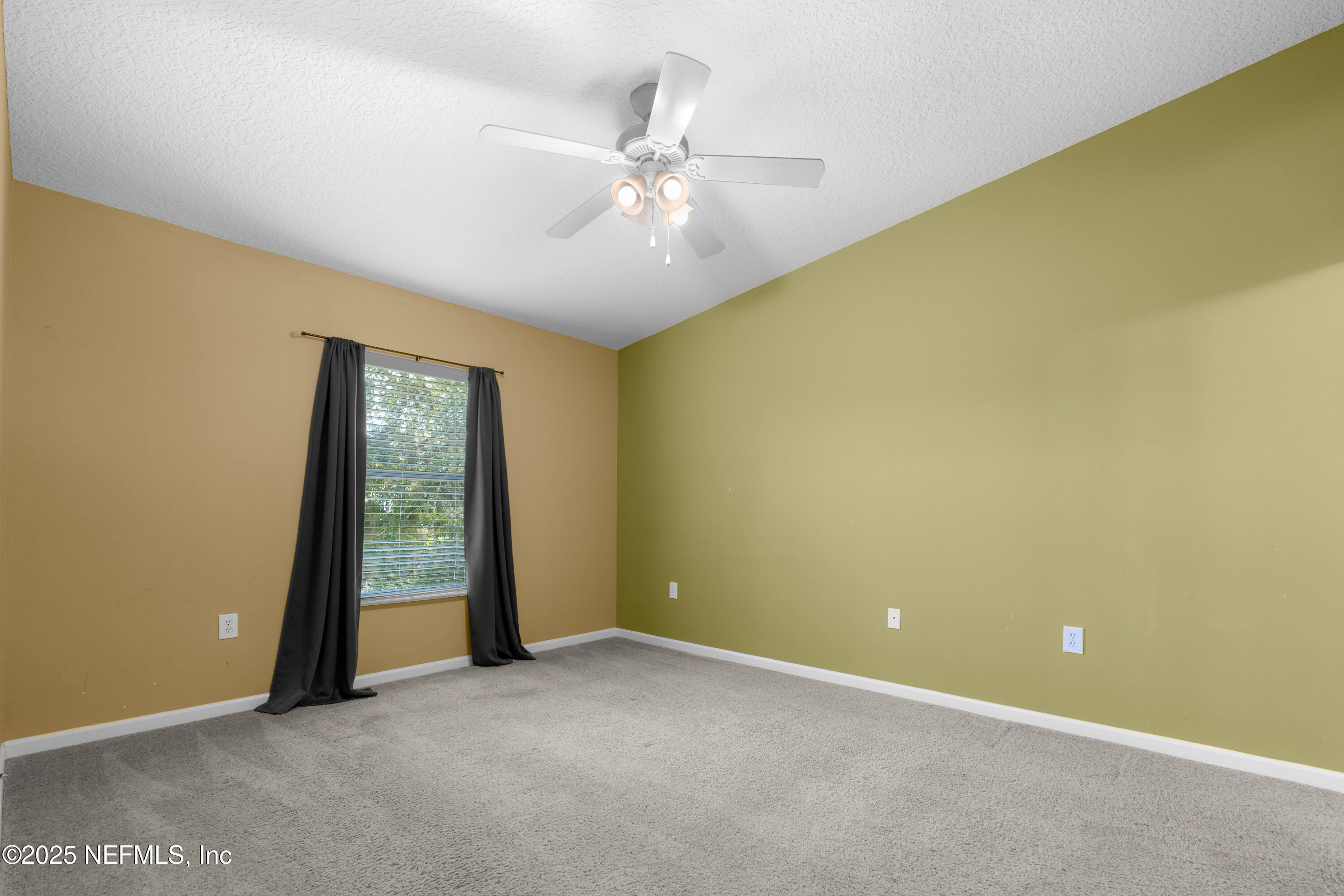 2784 Golden Lake Loop St. Augustine, FL 32084 - Photo 7 of 32 an empty room with a ceiling fan and a window