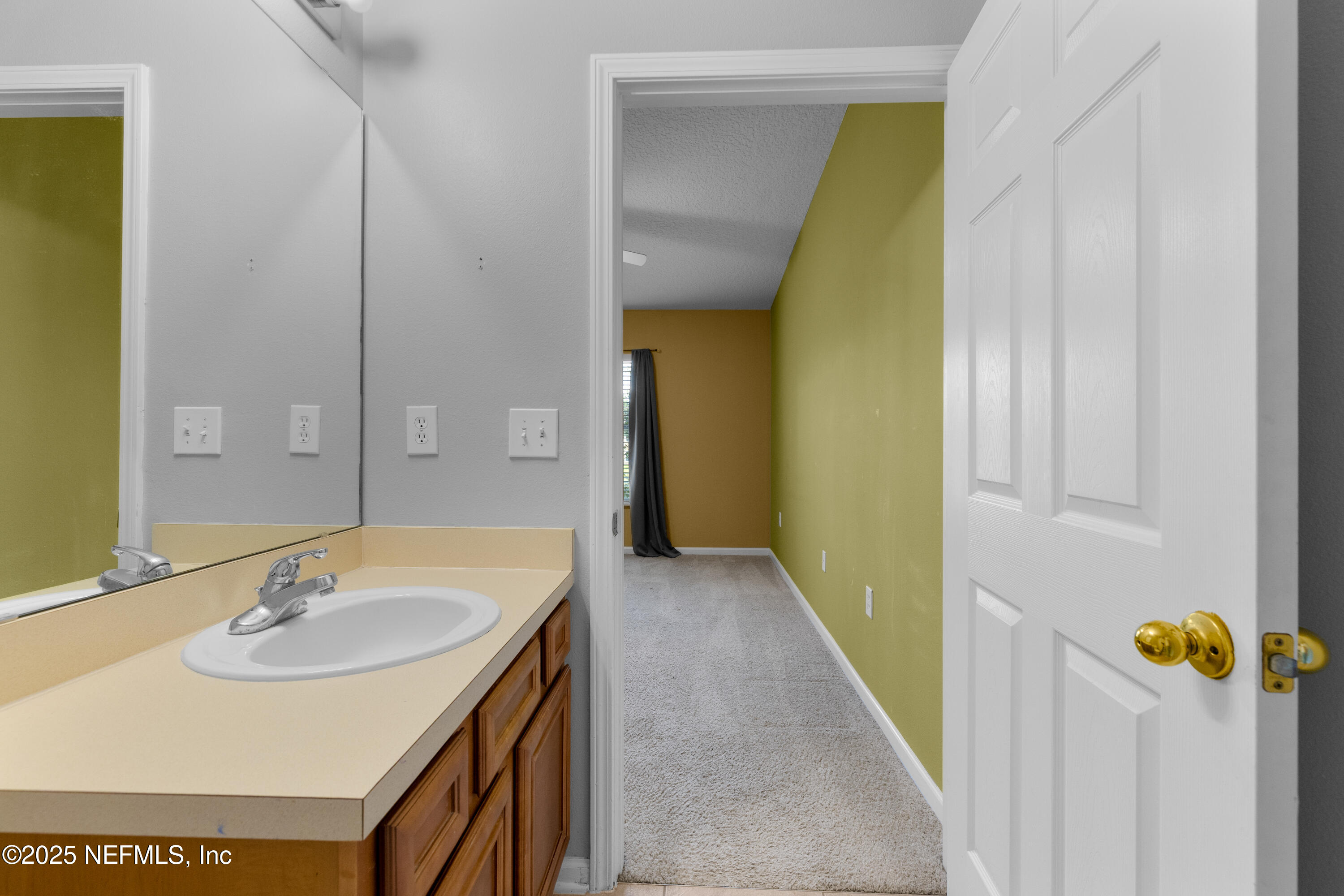 2784 Golden Lake Loop St. Augustine, FL 32084 - Photo 10 of 32 a bathroom with a sink and a mirror