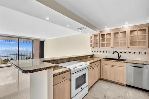 a view of an empty room with kitchen