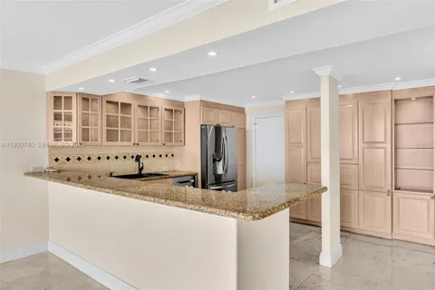 a kitchen with stainless steel appliances granite countertop a refrigerator sink and stove